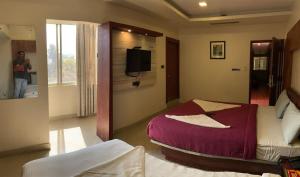 Postel nebo postele na pokoji v ubytování Hotel Adya Classsic