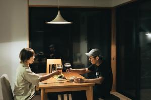 a man and woman sitting at a table with glasses of wine at フォレスト247 in Nagano