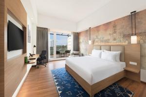 Voodi või voodid majutusasutuse Mercure Lucknow Gomti Nagar toas