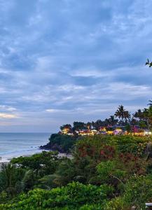 a view of a beach with houses and the ocean at Sandcastle Resort in Varkala
