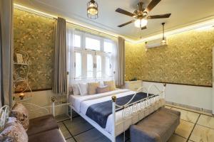 a bedroom with a bed and a window at Alaya Stays Anugrah Farm - 2 BHK Farmstay With Kids Room & Pvt Pool in Bahora +66 photos