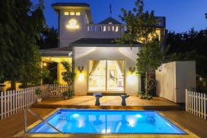 a house with a swimming pool in front of a house at Alaya Stays Anugrah Farm - 2 BHK Farmstay With Kids Room & Pvt Pool in Bahora