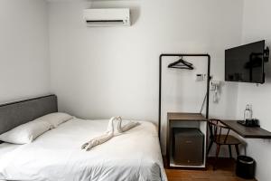 Postel nebo postele na pokoji v ubytování Earnest Hotel Georgetown