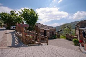 a house with a wooden fence in front of it at Apartamentos Casa Paulino in Taramundi