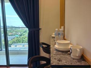 a room with a table with chairs and a window at Near Airport K Avenue Homestay by MINO Suites in Donggongon +105 photos