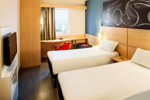Ein Bett oder Betten in einem Zimmer der Unterkunft ibis Macae