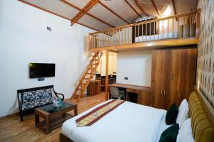 a bedroom with a bunk bed and a staircase at Monal Meadows in Bhīm Tāl