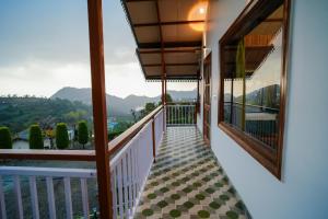 a balcony with a view of the mountains at Monal Meadows in Bhīm Tāl