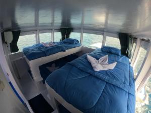 two beds in the back of a bus at Bajo Familia Tour And Travel in Komodo Labuan Bajo Airport