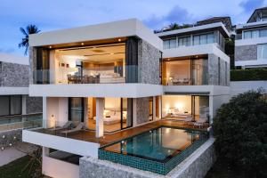 an exterior view of a house with a swimming pool at Villa Serenity Bay, Modern 4-BR Partial Sea View villa in Plai Laem