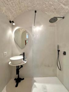a bathroom with a sink and a shower at CASSIODORO - Home & Terrace in Ostuni +29 photos