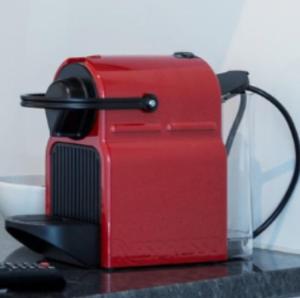 a red toaster sitting on top of a table at Superbe Studio en Plein Centre à Lausanne Gare in Lausanne
