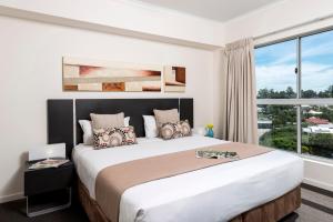 Ένα ή περισσότερα κρεβάτια σε δωμάτιο στο Oaks Ipswich Aspire Suites +13 φωτογραφίες