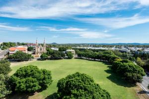 an aerial view of a park with trees and a church at Oaks Ipswich Aspire Suites in Ipswich