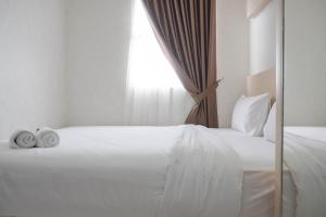 Postel nebo postele na pokoji v ubytování Comfort and Warm 2BR at Parkland Avenue Apartment By Travelio