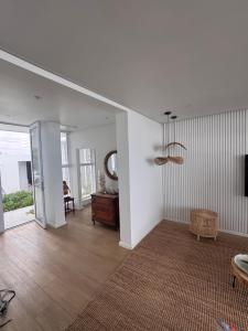 a living room with a table and a mirror at Sunset Shores in Lambertʼs Bay