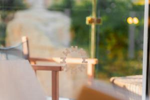 a view of a window with a table and a chair at Minura Cala Galdana & Apartamentos d'Aljandar in Cala Galdana
