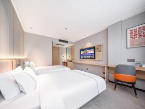 Vuode tai vuoteita majoituspaikassa Yiwu Yunjing Hotel