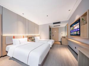 Vuode tai vuoteita majoituspaikassa Yiwu Yunjing Hotel