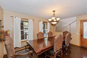 Un comedor con mesa y sillas de madera. en Big 10 Luxury Cabin/Walk to Snow Summit- HotTub, en Big Bear Lake