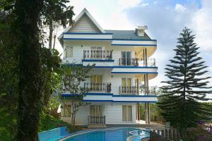 a large house with a swimming pool in front of it at The Heights Munnar in Munnar