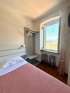 A bed or beds in a room at Belvedere Affittacamere