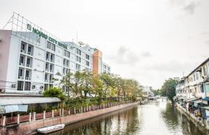 a river in a city with buildings next to a canal at Nouvo City Hotel in Bangkok
