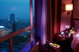 a room with a window with a view of a city at Crowne Plaza City Center Ningbo, an IHG Hotel - Near Ningbo Railway Station in Ningbo