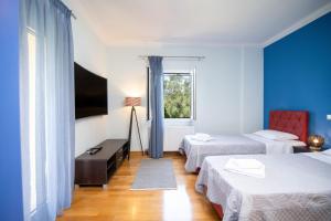 a hotel room with two beds and a window at Le Chateau by CorfuΕscapes in Corfu