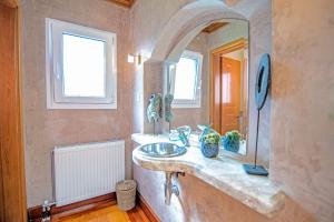 a bathroom with a sink and a mirror at Le Chateau by CorfuΕscapes in Corfu +97 photos