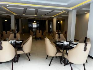 a dining room with a table and chairs at Royal Elite Hotel Kalam in Kalām +30 photos