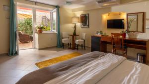 a bedroom with a bed and a desk and a deskablish at B&B Ciao Bella in Veli Lošinj +24 photos