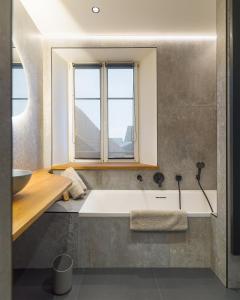 a bathroom with a large bath tub with a window at Ma.maison in Guémar +2 photos
