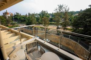 a balcony with two chairs and a table on a building at Luxury 1-Bedroom Apartment in Kigali