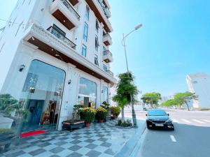 a car parked in front of a building at Blue Ocean Hotel Phan Thiết - by BAY LUXURY in Ấp Bình Hưng