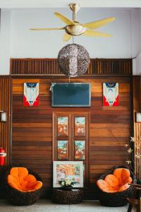 a room with two baskets of oranges and a ceiling fan at Pai Sukhothai Resort SHA Extra Plus in Sukhothai