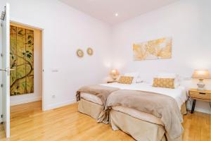 Łóżko lub łóżka w pokoju w obiekcie Juan Bravo Suites