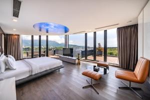 a bedroom with a large bed and large windows at Cami Riverside Resort Da Nang in Da Nang +112 photos