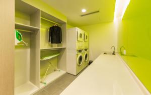 a green and white laundry room with a washer and dryer at Holiday Inn Express Changzhou Lanling, an IHG Hotel in Changzhou