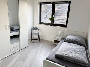 a bedroom with a bed and a window and a chair at House in Bergisch Gladbach in Bergisch Gladbach +5 photos