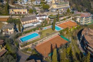 z góry widok na dom z dwoma kortami tenisowymi w obiekcie Casa dei Nonni Apartments w Tremosine Sul Garda