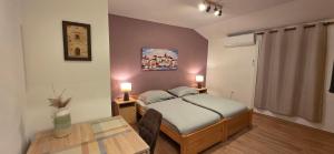 a bedroom with a bed and a table and a table sidx sidx sidx at Lighthouse Zadar Center Apartments in Zadar