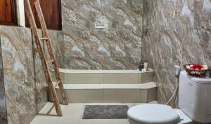 a bathroom with a ladder next to a toilet at Ananda B&B in Gili Air +37 photos