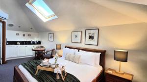 a bedroom with a large bed and a skylight at Sandstone Suites - In the heart of Port Fairy in Port Fairy