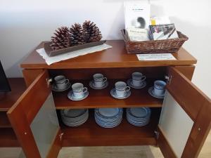 a shelf with cups and plates and a basket on it at La Teja del Jerte in Aldehuela del Jerte