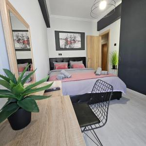 Un dormitorio con una cama y una planta en maceta. en Central 3 Modern Apartment with FREE parking, en Serres