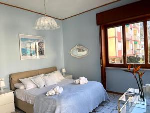 a bedroom with a bed with towels on it at Large family appartament with pool in Sorrento +27 photos