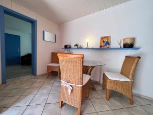 a dining room with a table and chairs at Lange Straße by Restaurant WIESENAU in Prerow