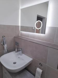 a bathroom with a sink and a mirror at Schäfers Fewo in Bad Arolsen +4 photos