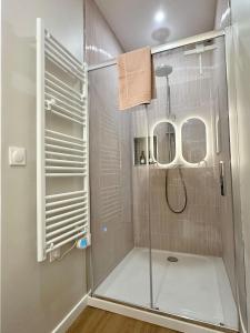 a shower with a glass door in a bathroom at L Arcade Chic & Confort - Terrasse - 5 min Gare in Amiens